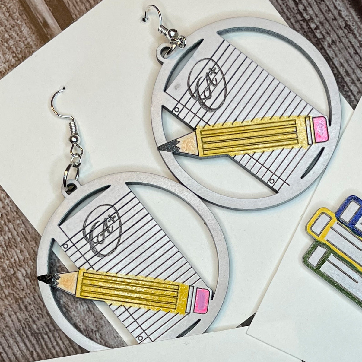 https://shop.glowforge.com/cdn/shop/files/TeacherEarrings-PencilA_RoundDangleEarrings-2square_1200x.jpg?v=1688850406