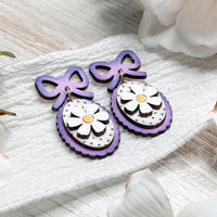 Whimsical Daisy Dangle Earrings with Bow Accent